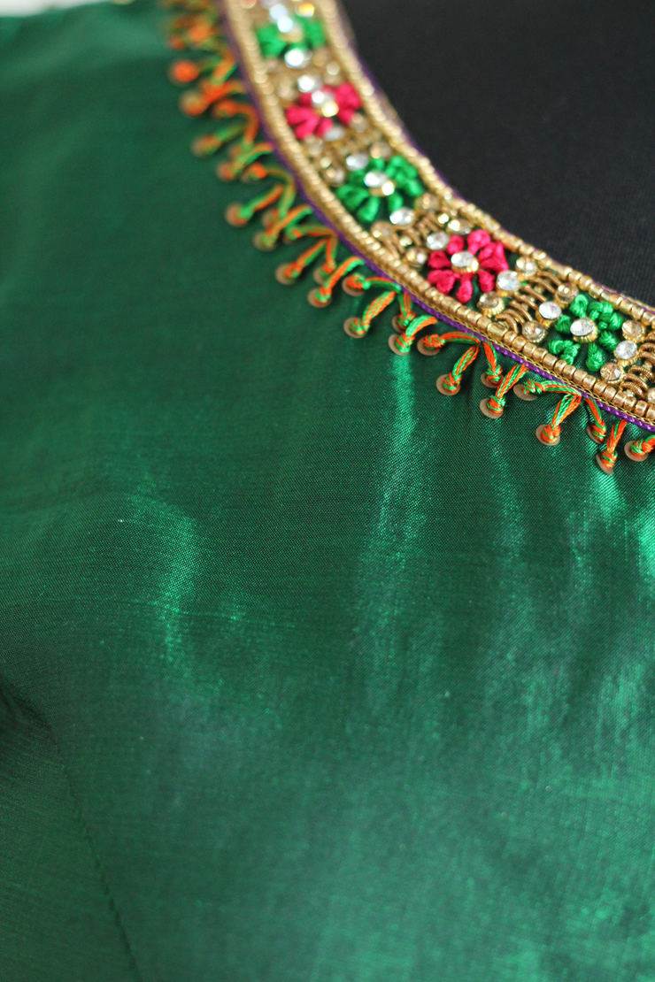  Green pure silk aari work in gold, red green blouse