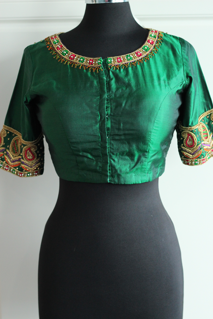 Green pure silk aari work in gold, red green blouse